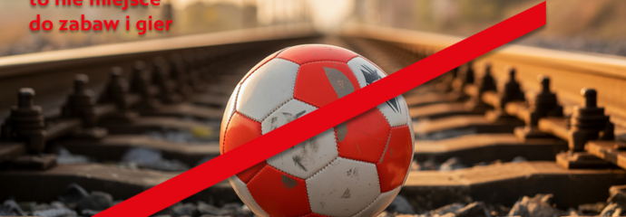 Przekreślona piłka leżąca na torach kolejowych